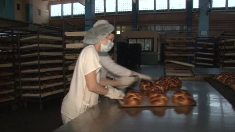 The oven in the bakery. Hot fresh bread leaves the industrial oven in a bakery. Stock Footage 230493556