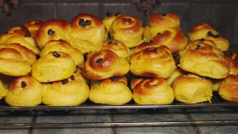 Oven baking delight: saffron buns with raisins rising to perfection Stock Footage 289221748