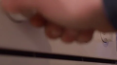 Oven control knobs pop out of panel: Setting, temperature adjusted 動画素材 265570002