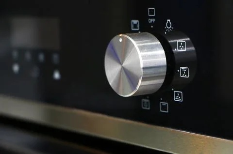 Oven knob controller with multi-function settings from side view Stock Photos