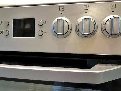 Oven knobs on metallic structure black and white. Stock Photos