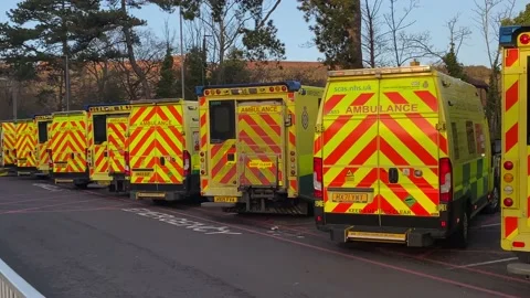 Over 30 ambulances queue at a Hospital Accident and Emergency department Stock Footage 227385848