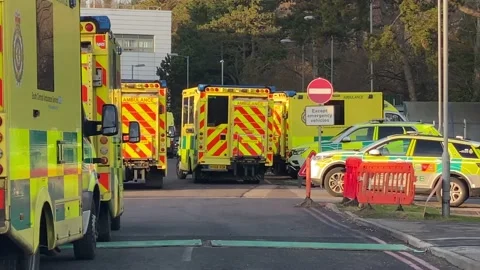 Over 30 ambulances queue at a Hospital Accident and Emergency department Stock Footage 227385849