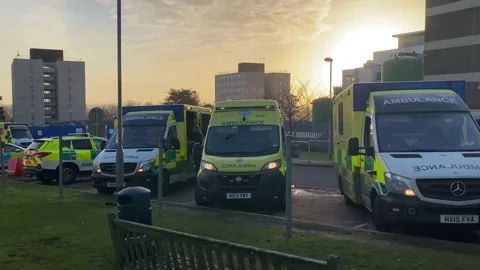 Over 30 ambulances queue at a Hospital Accident and Emergency department Stock Footage 227385872
