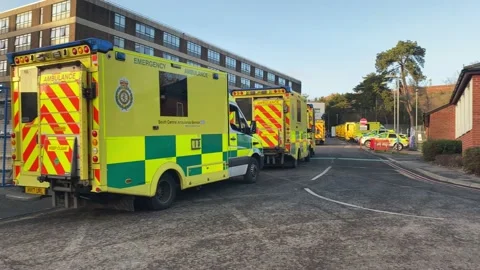 Over 30 ambulances queue at a Hospital Accident and Emergency department Stock Footage 227385924