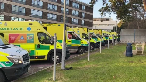 Over 30 ambulances queue at a Hospital Accident and Emergency department Stock Footage 227385949
