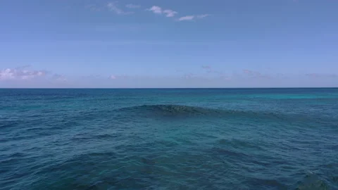 Over blue ocean with single breaking wave 4K Stock Footage 155770443