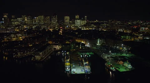 Over Boston's North End waterfront at night, downtown skyline in background. Vídeo Stock 59130170