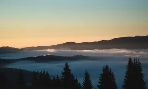 Over the clouds view, mountains in the background, sunrise Stock Photos
