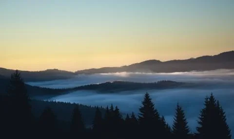 Over the clouds view, mountains in the background, sunrise Stock Photos