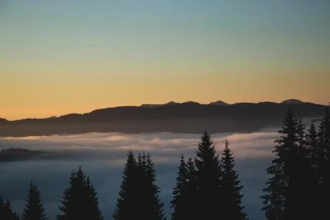 Over the clouds view, mountains in the background, sunrise Stock Photos