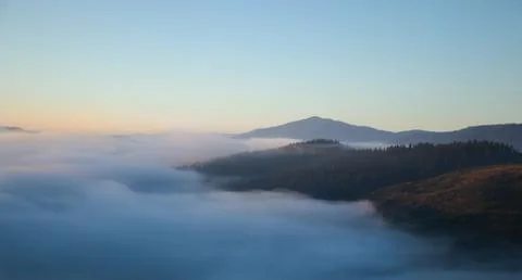 Over the clouds view, mountains in the background, sunrise Stock Photos