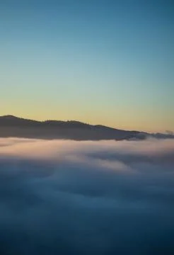 Over the clouds view, mountains in the background, sunrise Stock Photos