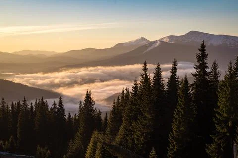 Over clouds view on snow capped mountain ranges landscape photo Stock Photos