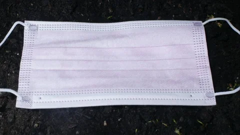 Over the days and weeks the grass grows under a surgical mask. Coronavirus time. Video stock 149106839