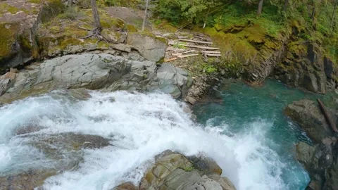Over the edge of a waterfall with beautiful blue pool, 4K Stock Footage 168910978
