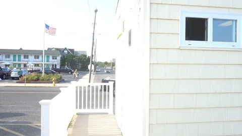 Over exposed slomo pan on beach town Stock Footage 98909300
