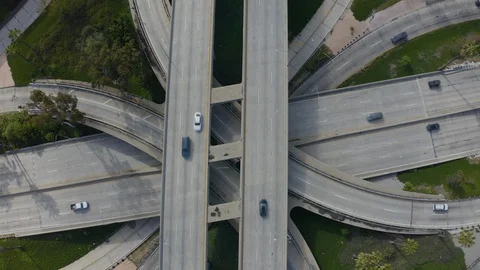 Over head drone shot of light Los Angeles freeway traffic during coronavirus Stock Footage 128227070
