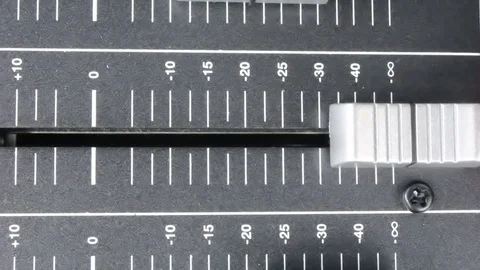 Over head position of a musician sliding the controls on a sound desk. Stock Footage 72221453