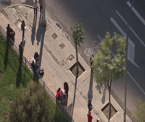 Over head view of people walking and setting up sales stalls on sidewalk Stock Footage 86745062