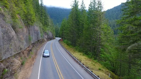 Over the higway with steep cliffs and fencing for falling rocks Video stock 96372364