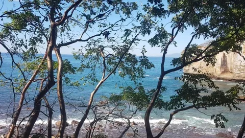 Over looking a Big Rock in The middle of the ocean Stock Footage 121941870