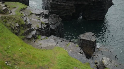 Over looking the sea lapping against the rocks Stock Footage 113304797