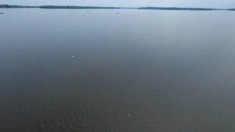 Over mother and son net fishing on pirogue Stock Footage 87118947