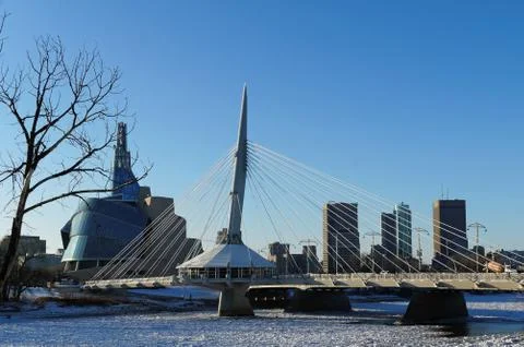 Over the Red River. Winter view on Esplanade Riel bridge with Canadian Museum Stock Photos