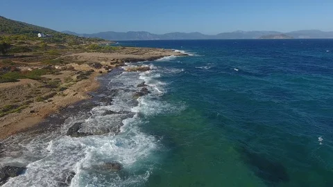 Over rocky coastline Stock Footage 128218512