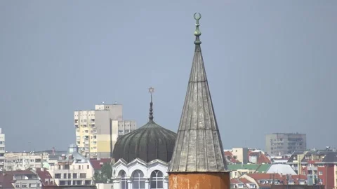 Over the rooftops of Sofia with synagogue dome and mosque minaret in downtown Stock Footage 335434714
