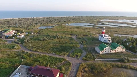 Оver the rural road past the lighthouse to the seashore Stock Footage