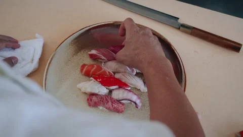 Over shoulder chef plating nigiri assortment 4K Stock Footage 317504677