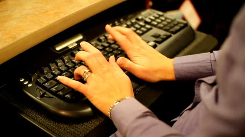 Over the shoulder dolly shot of woman typing Stock Footage