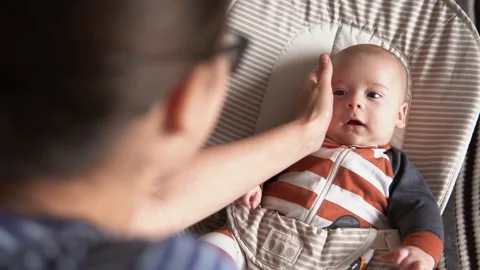 Over the shoulder face to face hold Childhood, motherhood, family. Little Stock Footage 166417849