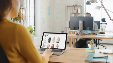 Over the Shoulder: Female Employee Browsed Through Online Retail Shopping Site. Stock Footage 112600054