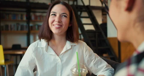 Over the shoulder Happy and cheerful brunette girl in a white shirt communicates Stock Footage 280295698