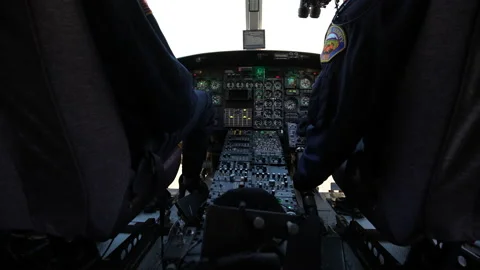 Over the Shoulder Helicopter Cockpit View of the control panels Pre-flight Stock Footage 197929644