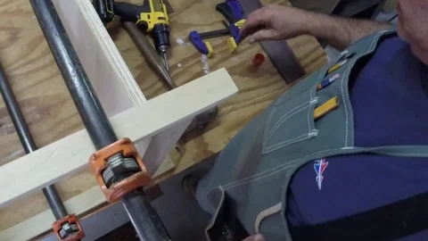 Over the shoulder of installing pocket screws in additional shelf. Stock Footage 81714595