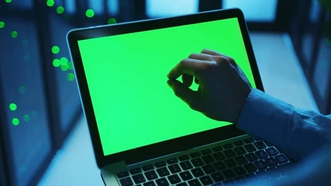 Over the shoulder IT expert using laptop computer for maintenance, working on Stock Footage 121116946