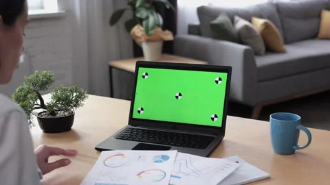 Over shoulder laptop screen view. Young woman has video call on laptop green Stock Footage 164531529