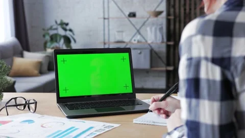 Over shoulder laptop screen view. Young woman has video call on laptop green Video stock 164531806