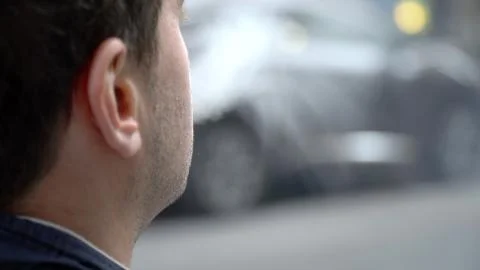 Over shoulder perspective view of young urban millennial hipster man smoking  Stock Photos