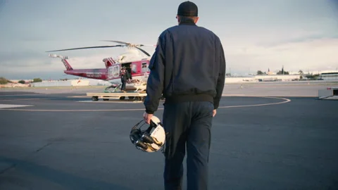 Over Shoulder POV of Pilot crossing the tarmac to portable Helicopter pad Stock Footage 203563686