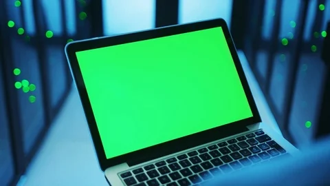 Over the shoulder professional IT engineer keyboarding on laptop mock-up green Video stock 121116747