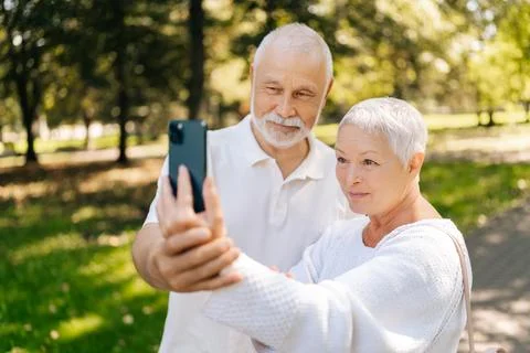 Over shoulder shot of charming elderly couple enjoying video call while Fotos Stock