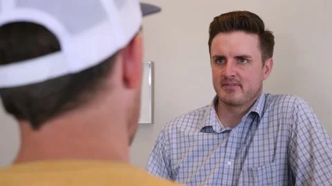 Over The Shoulder Shot Of A Customer Talking To A Salesman Stock Footage 133134766