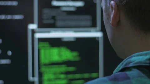 Over the shoulder shot of a hacker committing a cyber crime from home Stock Footage 142922284