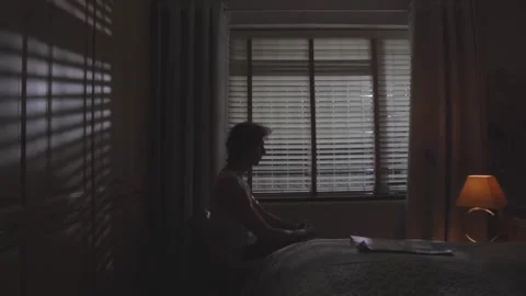 Over-Shoulder Shot of Man at Desk in Dimly Lit Introspective Mood Stock Footage 308613625