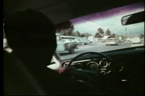 Over-the-shoulder shot of a man sitting in parked car Vídeos de archivo 11355349